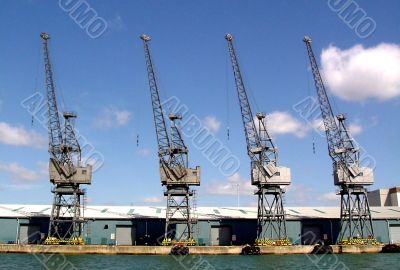 Four cranes at empty dockside