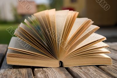 Open book on a wooden desk