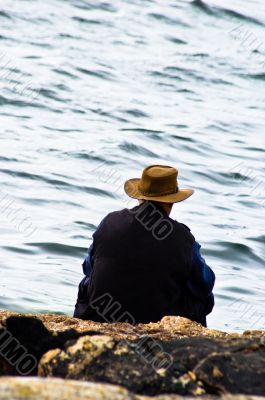 Man SItting Alone by Water