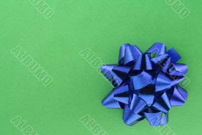 blue bow on green background