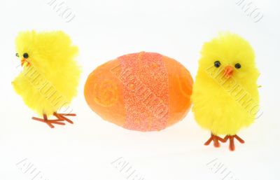 two toy chickens with decorated egg