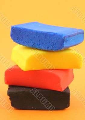 pile of colorful plasticine blocks on orange