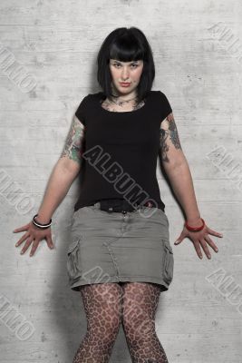 woman leans against a wall