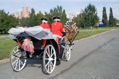 Ancient vehicle with the driver in a livery