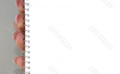 holding blank spiral notebook