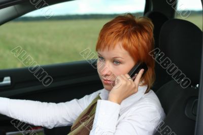 Red-haired woman with mobile-phone
