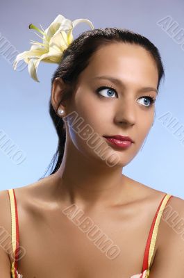 The beautiful girl with a lily in hair