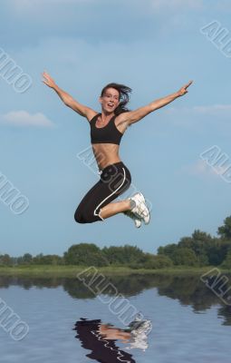 woman jumping above water