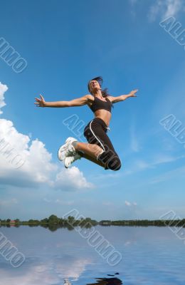 woman jumping above water