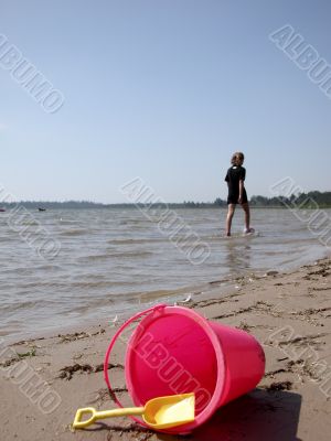 pink bucket on beach
