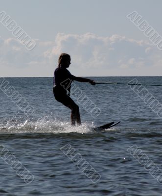 silhouette of girl waterskiing