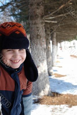 smiling boy against trees