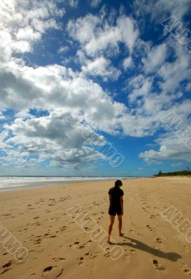 Lone woman walking at the beach