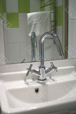 Green tiles, shiny faucet.