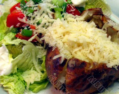 baked potato with cheese and salad