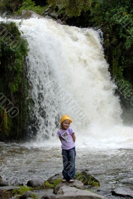 little girl near mountains waterfall