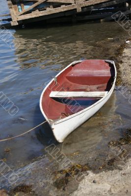 Dinghy on shore in harbor