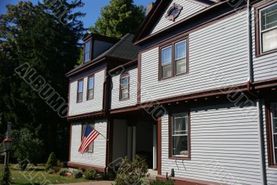 American flag and classic New England House