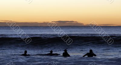 Surfers Paddling Out