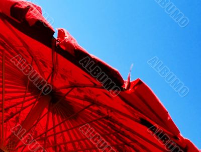 red parasol and blue sky