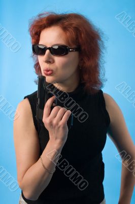red haired woman with pistol