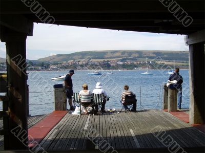 People fishing off pier