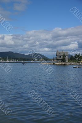 New England house & pier in harbor