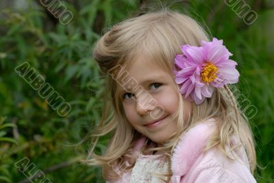 the little girl with a flower in hair