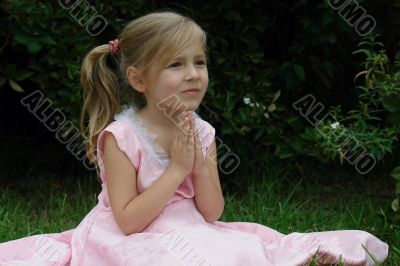 praying girl on the grass