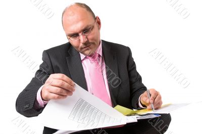 Checking his spreadsheets
