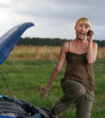 young blond woman with her broken car.