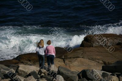 Young girls on beach rock