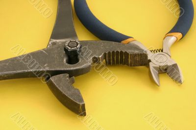 close-up of pliers on yellow