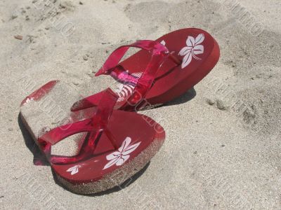 Red sandals on a sand