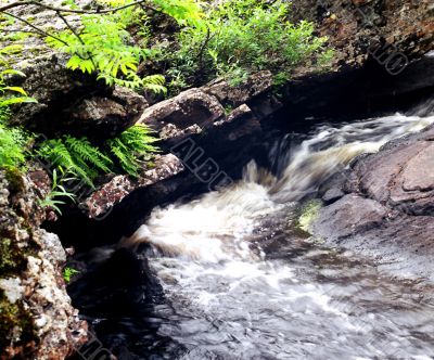 The fast small river among rocks.