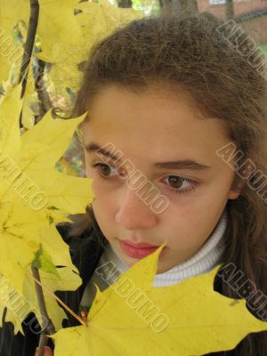 Sad girl with yellow leaves