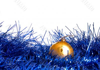 yellow ball lies on new-year tinsel