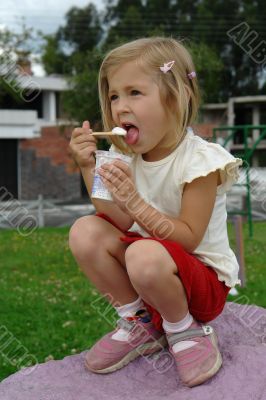little girl eats ice-cream