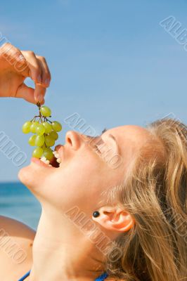 close up of girl eating grapes