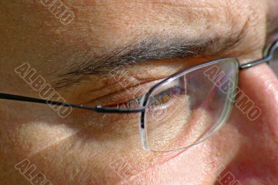 close up of eye and glasses