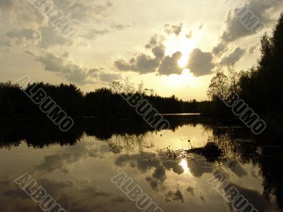 sunset above the forest river