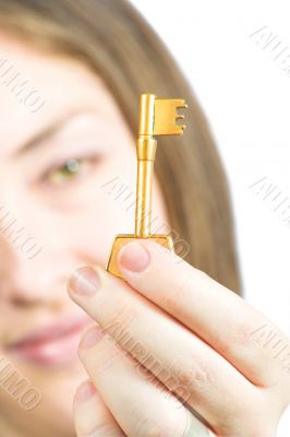 Woman holding a key of success in focs