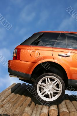 car 4 x 4 on wooden logs