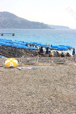 Beach with blue umbrellas