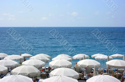Beach with white umbrellas