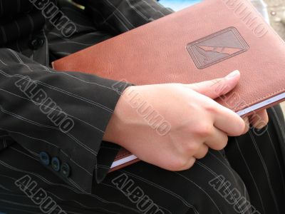 Girl`s hand with book