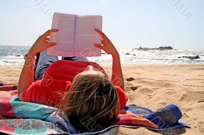 girl reading in the beach