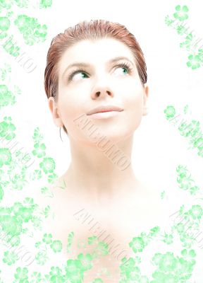 hi-key redhead with green eyes in water with flowers