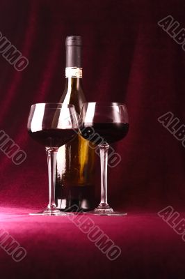 red wine in two glasses and bottle