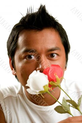 man holds 2 flowers